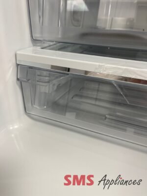 Open refrigerator door showing empty shelves and a plastic bag, with SMS Appliances logo at bottom.
